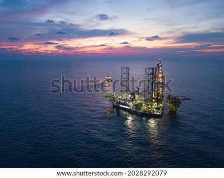 Offshore Jack Up Rig in The Middle of The Sea at Sunset Time for Petroluem Exploration and Production