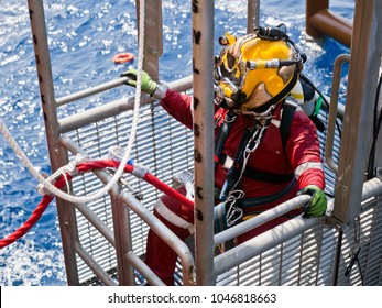 Offshore oil and gas diver in his diving cage during recovery back to deck after completing an underwater task on a newly installed jacket.