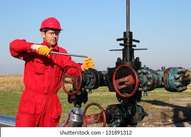 Offshore Oil Rig Operator.Oil Worker In Safety Gear With Hand Tool Working On Oil Rig Equipment.