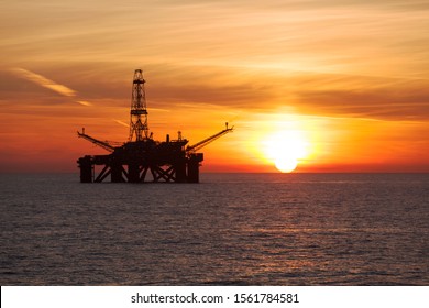 Offshore oil rig at sunset