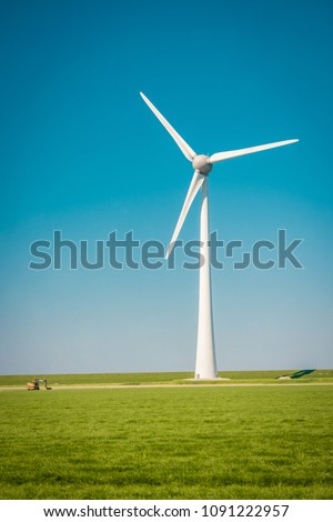 Offshore and Onshore Windmill farm in the ocean ,windmills isolated at sea on a beautiful bright day Netherlands Flevoland Noordoostpolder 