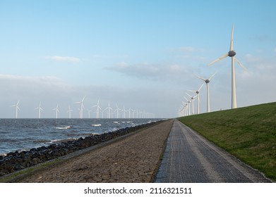 offshore and onshore windmills, the future of sustainable energy and  circular economy. - Shutterstock ID 2116321511