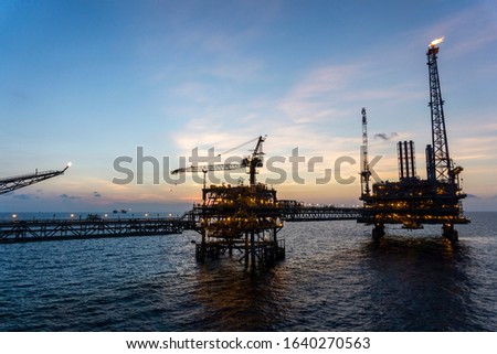 Offshore production platforms complex connected with bridges at oil field