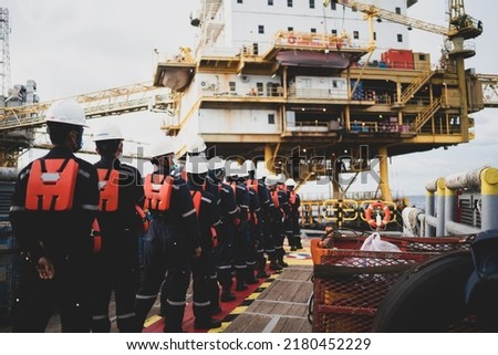 Offshore queuing workers work on decks during disembarkation operations to rest on the rig.