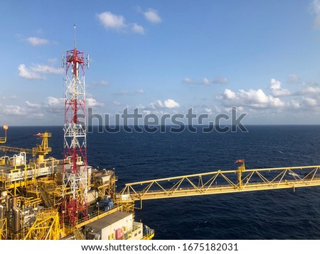 Offshore Rig Platform in the Middle of Gulf and Offshore oil and gas platform comprised of living quarter, central processing platform and well head platform with exhaust pipe and weather radar.