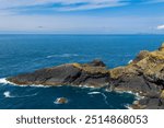 Offshore rocks and cliffs in the Irish Sea next to Skomer Island, Pembrokeshire, Wales