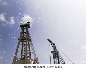 Offshore Tender Rig Crane Tower Tender Rig Or Barge Or Derrick Of Tender Assisted Drilling Oil Rig (Barge Oil Rig) On The Production Platform During Cloudy Sky And White Snow