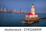 An offshore white cylindrical lighthouse standing just east of Navy Pier, guiding vessels into Chicago Harbor since 1893 and framed by the city skyline.Built during the 1893 World’s Fair, symbolizing Chicago’s growth as a Great Lakes powerhouse.

Originally painted a darker color; later repainted white for higher visibility.
The offshore placement protects vessels from the dangerous shoals at the harbor entrance.  On clear days, it creates one of the most photographed skyline compositions in the Midwest.

Frequently encased in dramatic ice formations during harsh winters.