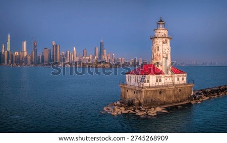 An offshore white cylindrical lighthouse standing just east of Navy Pier, guiding vessels into Chicago Harbor since 1893 and framed by the city skyline.Built during the 1893 World’s Fair, symbolizing Chicago’s growth as a Great Lakes powerhouse.

Originally painted a darker color; later repainted white for higher visibility.
The offshore placement protects vessels from the dangerous shoals at the harbor entrance.  On clear days, it creates one of the most photographed skyline compositions in the Midwest.

Frequently encased in dramatic ice formations during harsh winters.
