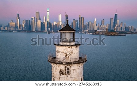 An offshore white cylindrical lighthouse standing just east of Navy Pier, guiding vessels into Chicago Harbor since 1893 and framed by the city skyline.Built during the 1893 World’s Fair, symbolizing Chicago’s growth as a Great Lakes powerhouse.

Originally painted a darker color; later repainted white for higher visibility.
The offshore placement protects vessels from the dangerous shoals at the harbor entrance.  On clear days, it creates one of the most photographed skyline compositions in the Midwest.

Frequently encased in dramatic ice formations during harsh winters.