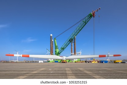 Offshore Wind Energy Turbine Supply Vessel Anchored And Loading Rotor In Port Harbor