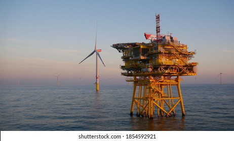 Offshore Wind Farm Substation With Turbine In North Sea