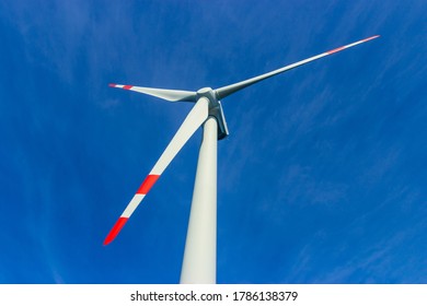 Offshore Wind Turbine On A Blue Sky Background