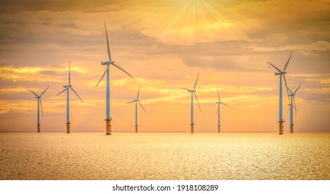 Offshore Wind Turbine in a Windfarm under construction off the England Coast at sunset