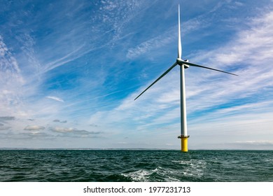 Offshore Windfarm Turbine And Expanse Of Sea And Sky