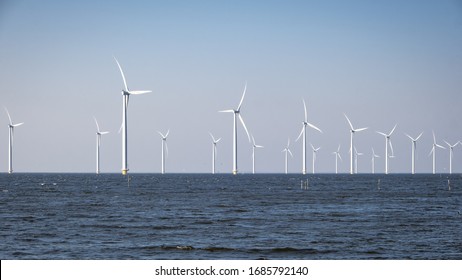 Offshore Windmill Farm In The Ocean Westermeerwind Park , Windmills Isolated At Sea On A Beautiful Bright Day Netherlands Flevoland Noordoostpolder