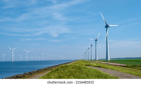 Offshore Windmill farm in the ocean Westermeerwind park, windmills isolated at sea on a beautiful bright day Netherlands Flevoland Noordoostpolder. Huge windmill turbines