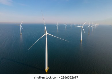 Offshore Windmill farm in the ocean Westermeerwind park, windmills isolated at sea on a beautiful bright day Netherlands Flevoland Noordoostpolder. Huge windmill turbines - Shutterstock ID 2166352697
