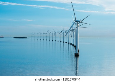 Offshore Windmill Park Alternative Energy. Windmills In The Sea With Reflection Morning