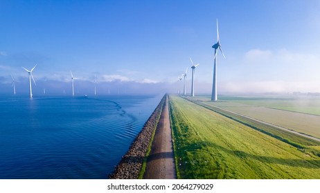 offshore windmill park and clouds   blue sky  windmill park in the ocean aerial view and wind turbine Flevoland Netherlands Ijsselmeer  Green energy 