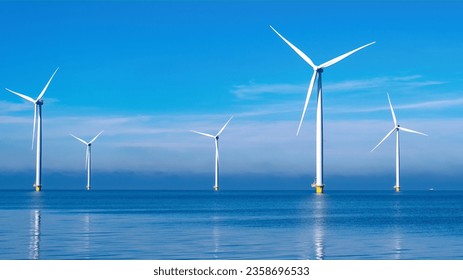 offshore windmill park with clouds and a blue sky, windmill park in the ocean aerial view with wind turbine Flevoland Netherlands Ijsselmeer. Green Energy in the Netherlands - Powered by Shutterstock