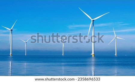 offshore windmill park with clouds and a blue sky, windmill park in the ocean aerial view with wind turbine Flevoland Netherlands Ijsselmeer. Green Energy in the Netherlands