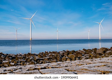 offshore windmill park with stormy clouds and a blue sky, windmill park in the ocean. Netherlands . Europe, windmill turbines in ocean with blue sky, green energy concept