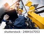 Offshore worker inspect with tablet drilling rig for exploration of minerals for oil, gas and artisan water. Concept smart online Industry.