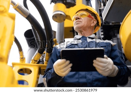 Offshore worker inspect with tablet drilling rig for exploration of minerals for oil, gas and artisan water. Concept smart online Industry.