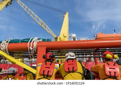 Offshore Worker Leaning On The Guard Rail Of A Tug Boat While Waiting To Be Transferred To A Construction Work Vessel At Oil Field