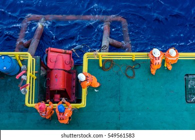 Offshore workers consist of riggers preparing to perform anchor handling on a construction barge at oil filed