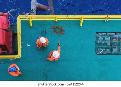 Offshore Workers Having A Discussion Prior To Anchor Handling Activity At A Bow Of A Construction Barge At Oilfield Terengganu, Malaysia