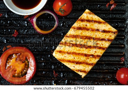 ofu on the grill on the table on a black background, view from the top.