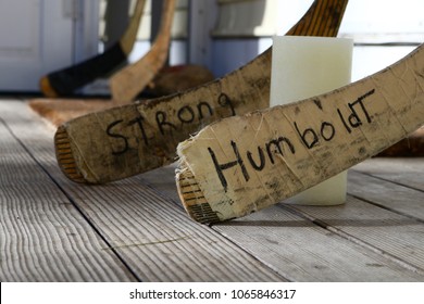 Ogunquit, Maine, USA: April 10, 2018: Hockey Sticks Surround And Candle On A Porch In A Tribute To The Canadian Hockey Team Killed In A Bus Crash In Saskatchewan, Canada.