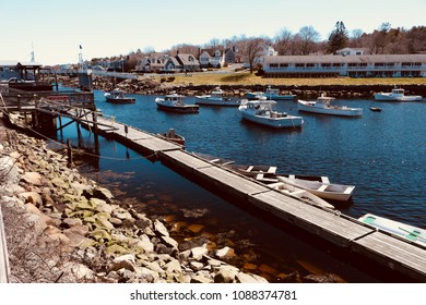 Ogunquit, Maine, USA: April 25, 2018: A wide shot of fishing boats moored in Perkins Cove, Maine on a sunny spring day.  Perkins cove is a representation of a fisherman’s life along the Maine coast.