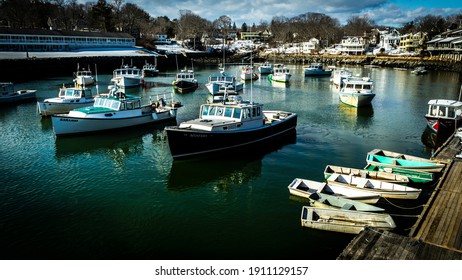 Ogunquit, Maine, USA-February 6, 2021: Lobster and Dory boats moored in Perkings Cove during the winter.