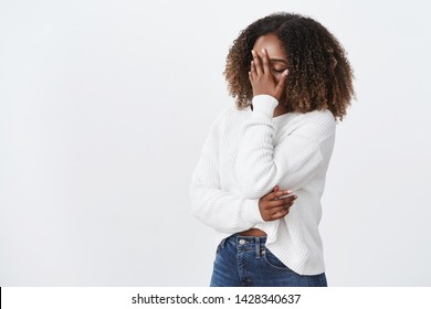 Oh god why me. Portrait tired exhausted emotive african-american curly-haired woman facepalming press palm face close eyes exhausted, look bothered annoyed dumb pick-up lines, white background