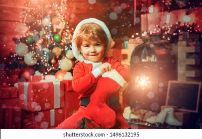 Oh Happy Day. Child Cheerful Face Got Gift In Christmas Sock. Contents Of Christmas Stocking. Joy And Happiness. Childhood Moments. Kid Boy Santa Hold Christmas Gift. Christmas Stocking Concept.