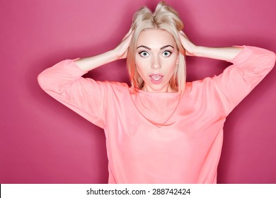 Oh My God. Portrait Of Young Pretty Woman Touching Her Hair With Great Amazement On Isolated Pink Background