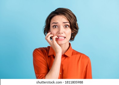 Oh no I failed again. Closeup photo of sad terrified lady horrified facial expression made big mistake feel guilty bite lips fingers wear orange shirt isolated blue color background - Shutterstock ID 1811805988