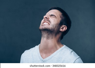 Oh No! Frustrated Young Man Keeping Eyes Closed And Expressing Negativity While Standing Against Grey Background