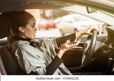 Oh, No! I Hit Someone With My Car. Woman Texting While Driving. Beautiful Blonde Woman Driving Her Automobile And Texting On Her Smartphone.