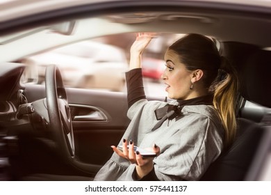 Oh, No! I Hit Someone With My Car. Woman Texting While Driving. Beautiful Blonde Woman Driving Her Automobile And Texting On Her Smartphone.