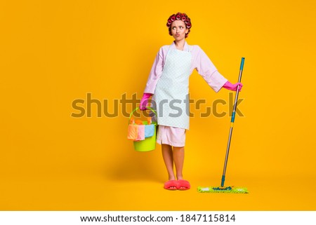 Oh no many chores . Upset girl hold bucket mop look copyspace wear bath robe isolated bright color background