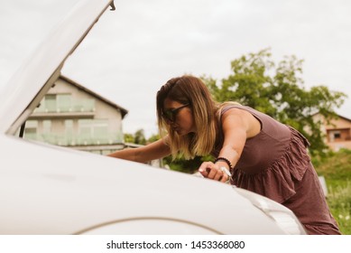 Oh No, My Car Broke Down. A Woman Next To A Car With An Open Hood