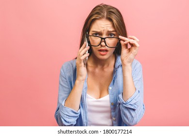 Oh No! Really? Shocked Young Woman Using Mobile Phone, Wearing Casual, Isolated On Pink Background.