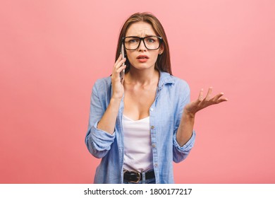 Oh No! Really? Shocked Young Woman Using Mobile Phone, Wearing Casual, Isolated On Pink Background.