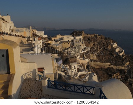 Oia town, Santorini island, Greece: Traditional and famous white houses and churches with blue domes over the Caldera, Aegean sea.