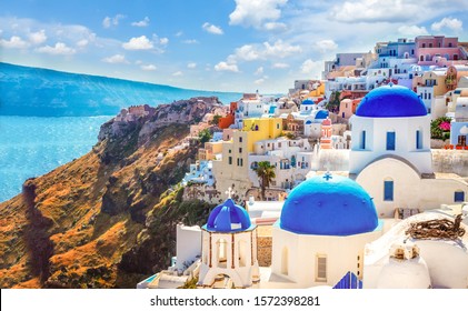 Oia, traditional greek village of Santorini with blue domes of churches under sky with flowers, Greece, web banner format - Powered by Shutterstock