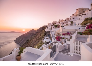 Oia village at night, Santorini island. Famous travel landscape, luxury vacation destination scenic. Beautiful view of fabulous picturesque village colorful sky, traditional white houses, romantic